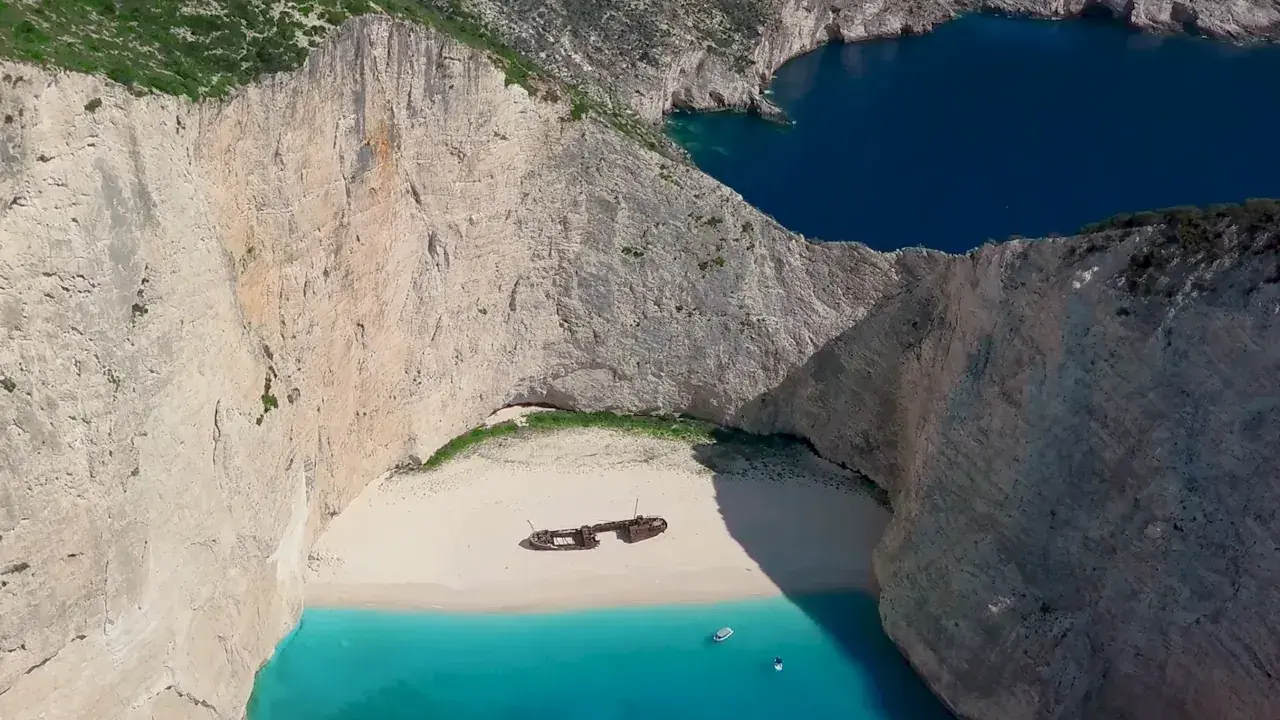 Navagio, jedna z najpiękniejszych plaż Zakynthos, z wrakiem statku na białym piasku i turkusową wodą.