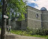 Obserwatorium astronomiczne na Lubomirze, kamienny budynek z kopułą, obok szlak turystyczny.